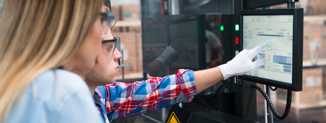 workers looking at a screen in manufacturing